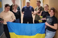 En grupp studenter med skruvdragare och Ukrainas flagga.